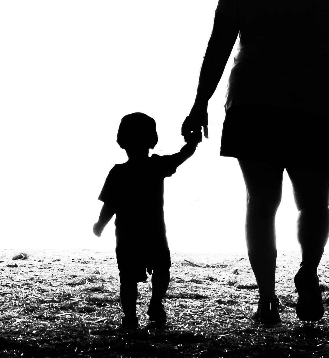 embraced hands of mother and child in silhouette